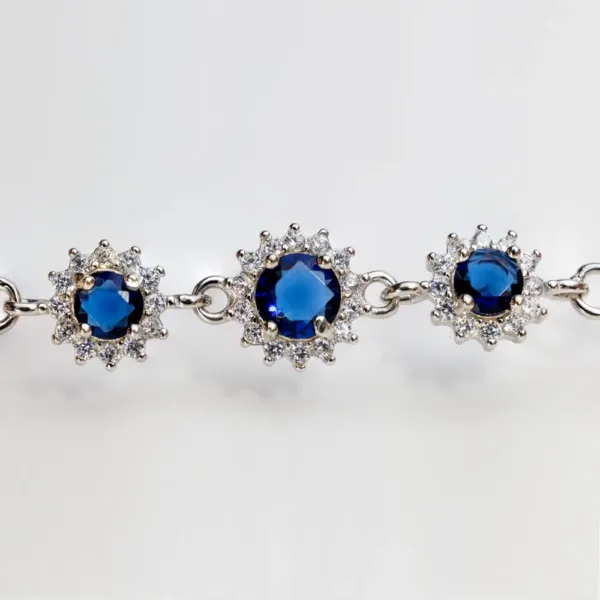 Luxury 925 silver bracelet with three sapphire-inspired crystals, each surrounded by cubic zirconia in floral design