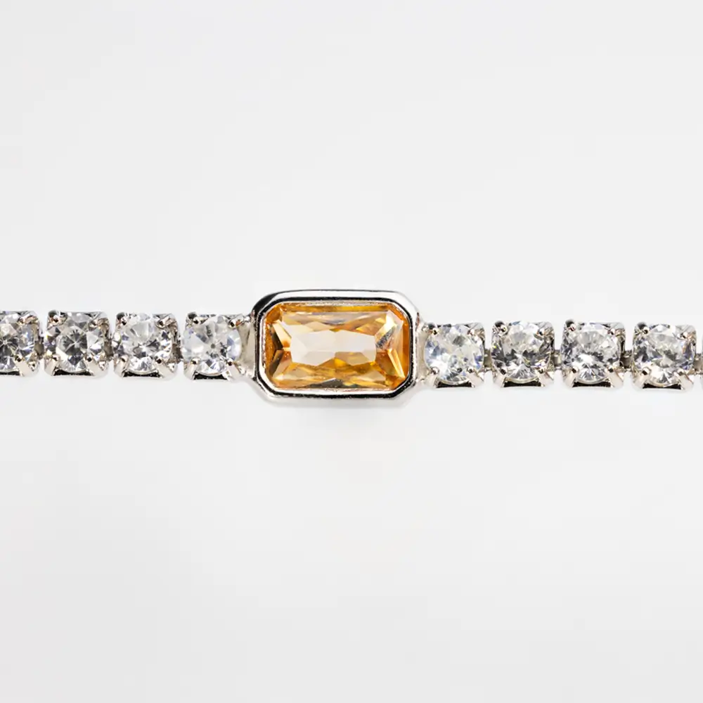 Close-up of Orange Gemstone Accent on 925 Silver Tennis Bracelet with Cubic Zirconia Stones