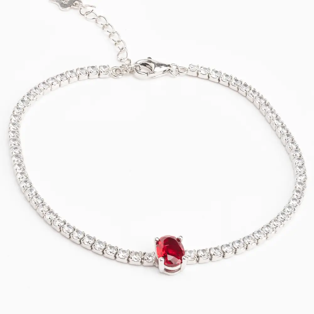 Delicate 925 silver tennis bracelet featuring a row of cubic zirconia stones and a prominent oval-cut red gemstone centerpiece