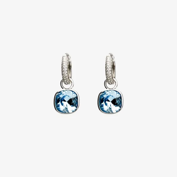 A pair of silver hoop earrings with a smaller diamond-encrusted hoop at the top and a larger, light blue cushion-cut gemstone dangling below.