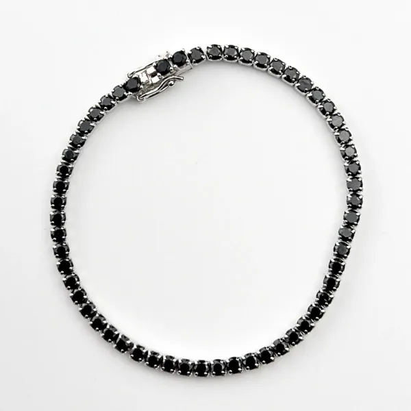 A delicate sterling silver tennis bracelet featuring sparkling black gemstones.