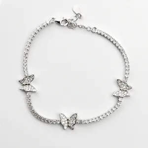 A delicate sterling silver tennis bracelet adorned with three sparkling butterfly charms, each embellished with clear cubic zirconia stones.