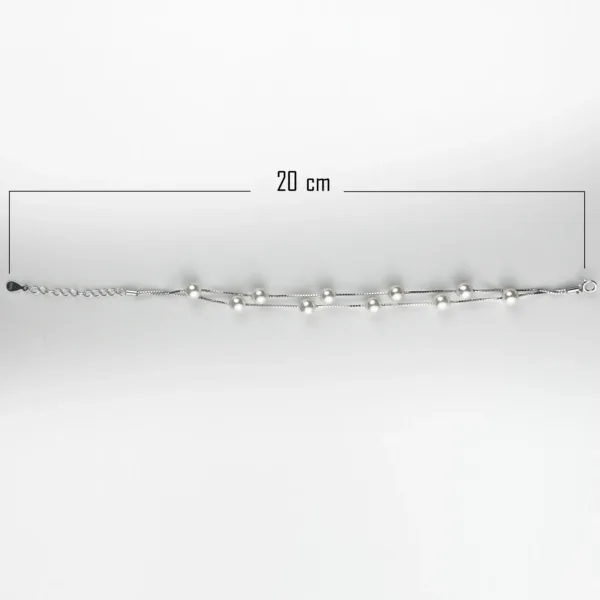 A sterling silver double-strand bracelet with evenly spaced white pearls, measuring 20 cm in length.