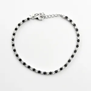 A sterling silver tennis bracelet featuring alternating black and white cubic zirconia stones in a classic prong setting.