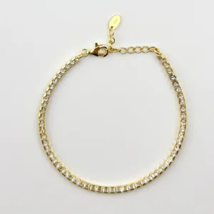 A gold tennis bracelet with square cubic zirconia stones.