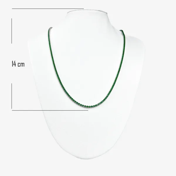 A silver tennis necklace measuring 14 cm in length, with small square-cut emerald gemstones.