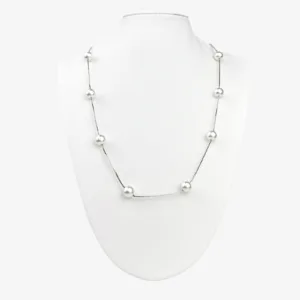 A silver ball chain necklace with evenly spaced silver beads displayed on a white mannequin bust.