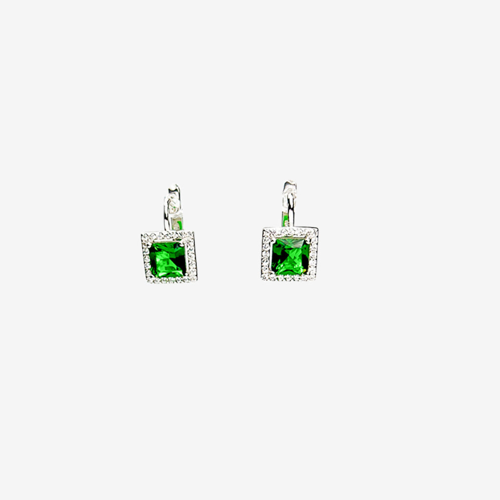 A pair of silver leverback earrings with square-cut emerald green gemstones surrounded by small, clear gemstones.