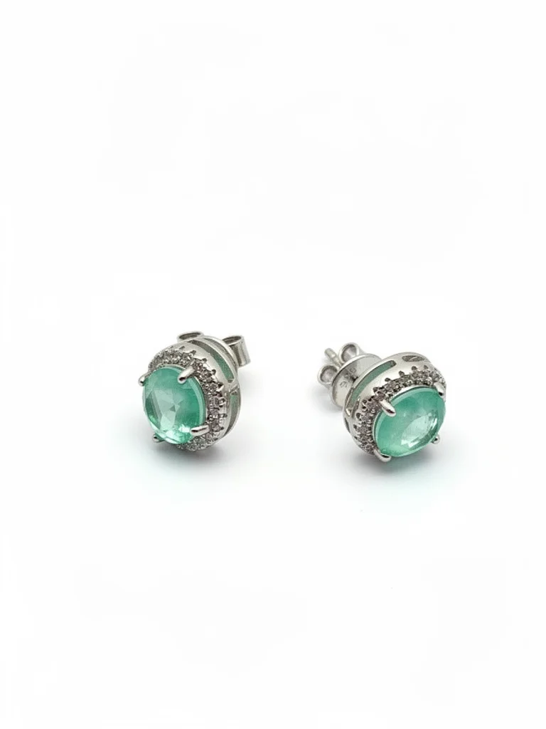 Sterling silver stud earrings with emerald green stones, front view