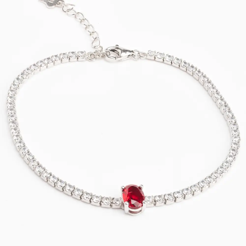 Sterling silver tennis bracelet with ruby CZ centerpiece, front view
