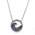 Sterling silver wave pendant necklace with blue accents, front view