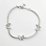 Sterling silver tennis bracelet with butterfly charms, top view