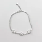 Sterling silver tennis bracelet with triple halo clusters, top view