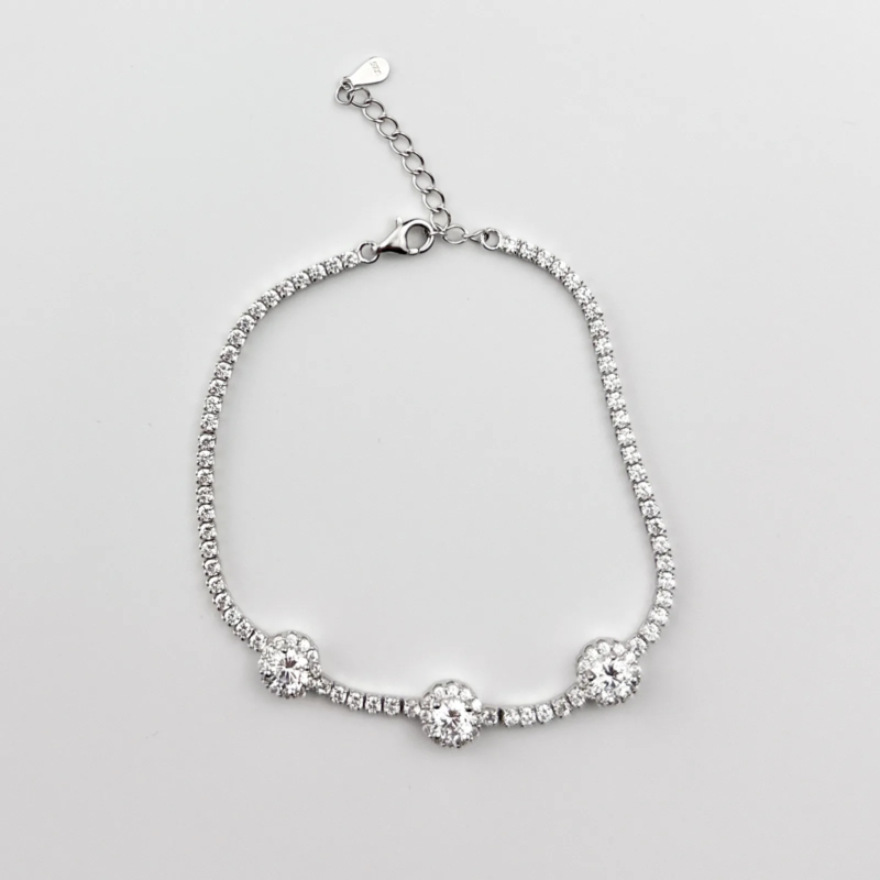 Sterling silver tennis bracelet with triple halo clusters, top view