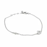 Sterling silver bracelet with heart and cross charm, lobster clasp, side view