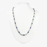 Sterling silver tennis necklace with alternating blue and clear gemstones, front view