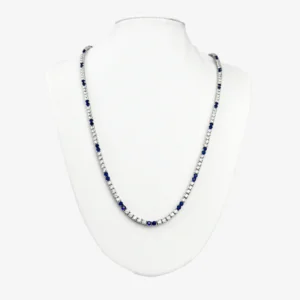 Sterling silver tennis necklace with alternating blue and clear gemstones, front view