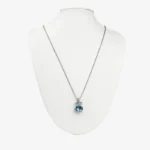 Sterling silver necklace with blue crystal pendant, front view
