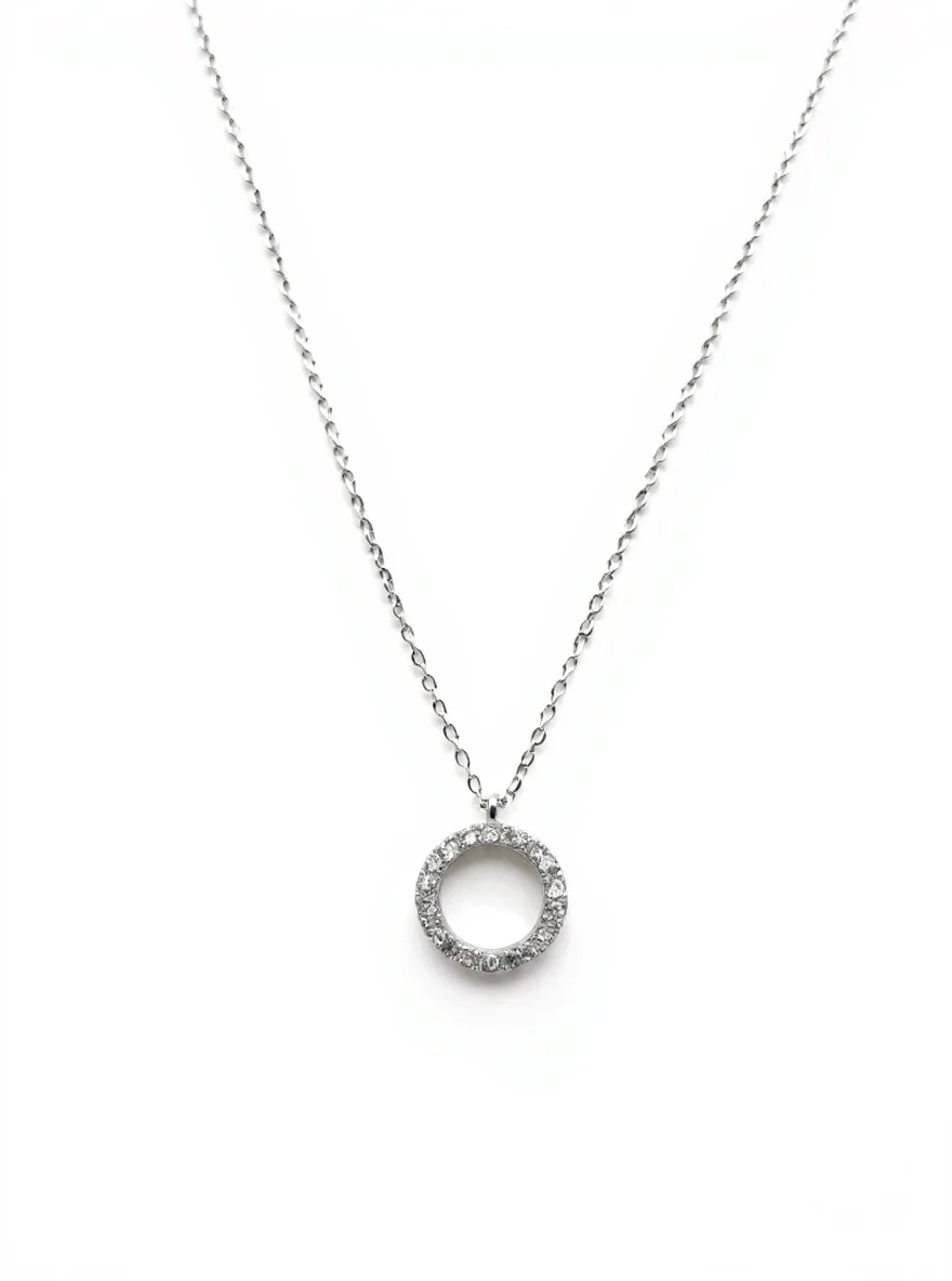 Sterling silver circle pendant with cubic zirconia on chain, front view