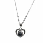 Sterling silver heart pendant with black stone on chain, front view