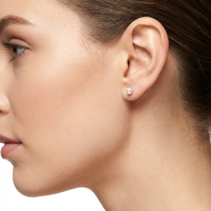 Sterling silver pearl stud earrings with butterfly backs, side view