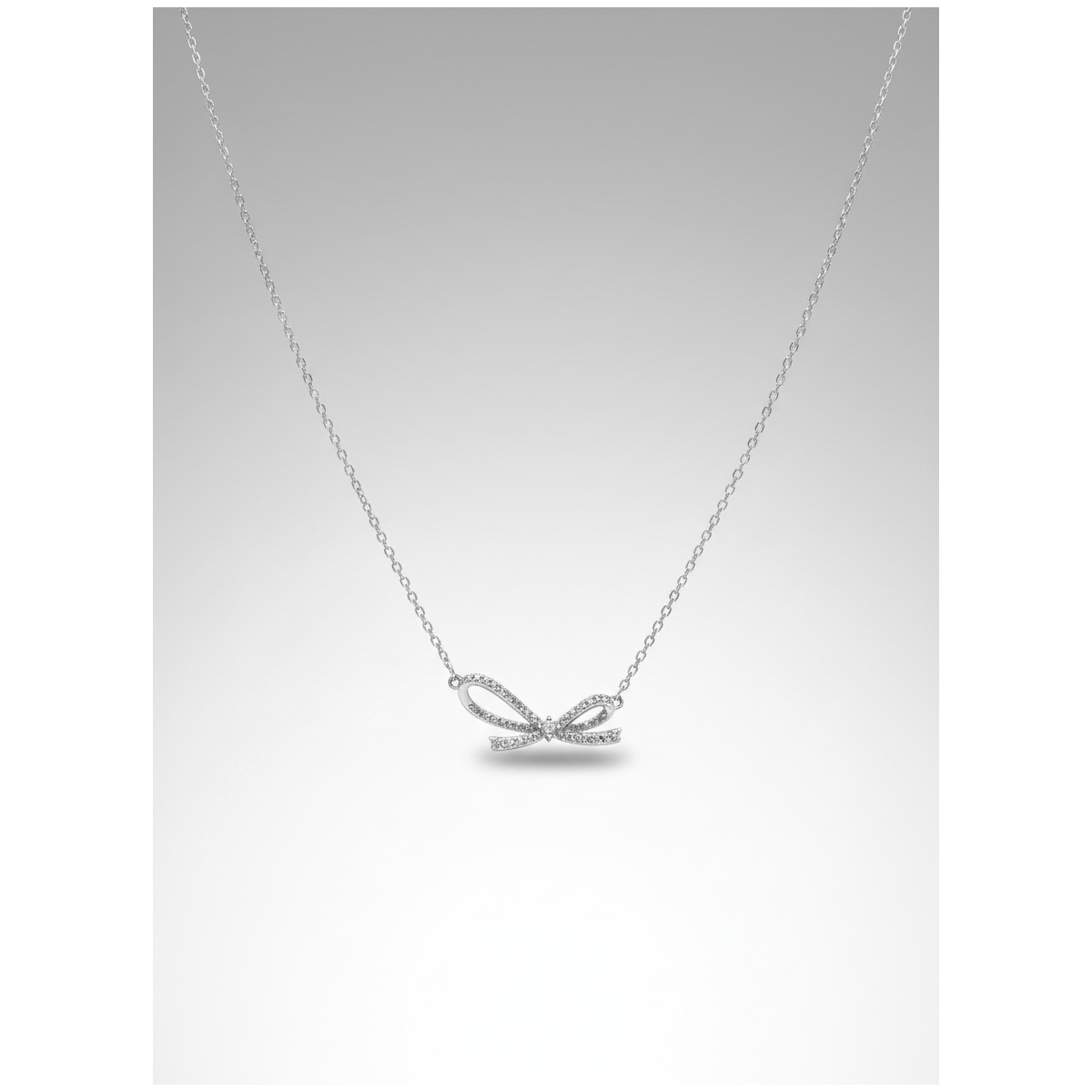 Sterling silver bow pendant necklace on delicate chain, front view