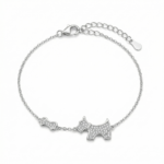 Sterling silver bracelet with dog and bone charms, featuring cubic zirconia, top view