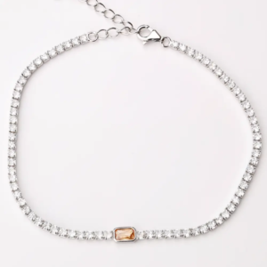 Sterling silver tennis bracelet with cubic zirconia and orange gemstone, top view