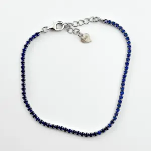 Sterling silver blue tennis bracelet with lobster clasp, top view