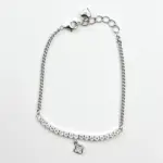 Sterling silver tennis bracelet with cubic zirconia and charm, top view