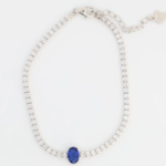 Sterling silver tennis bracelet with blue sapphire clasp, top view